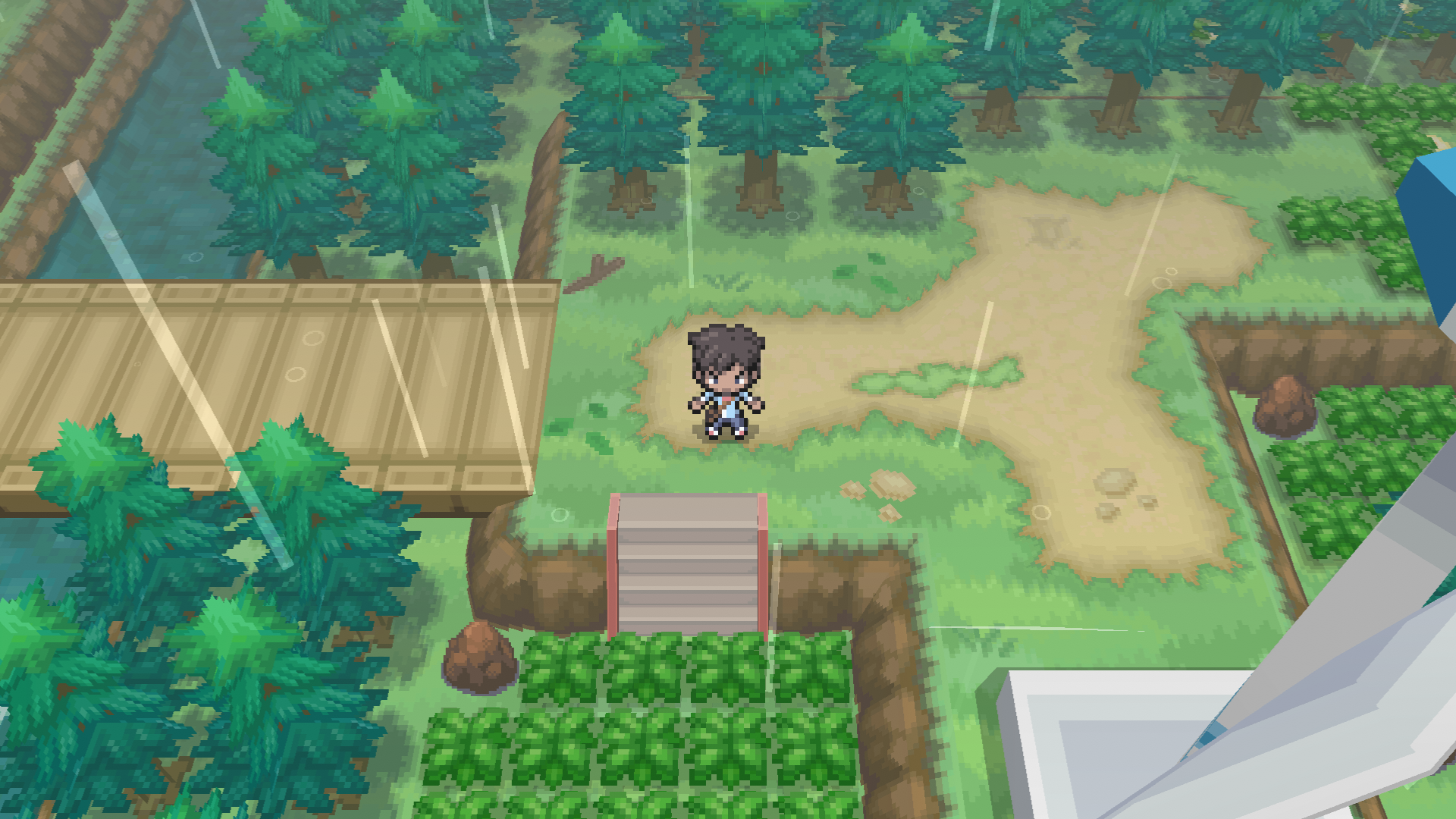 A trainer in a field, next to a wind turbine